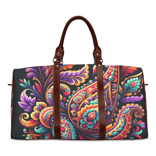 Vivid Luxe Paisley Duffel Bag with a bold colorful paisley print, waterproof fabric, and brown leather straps for stylish travel.
