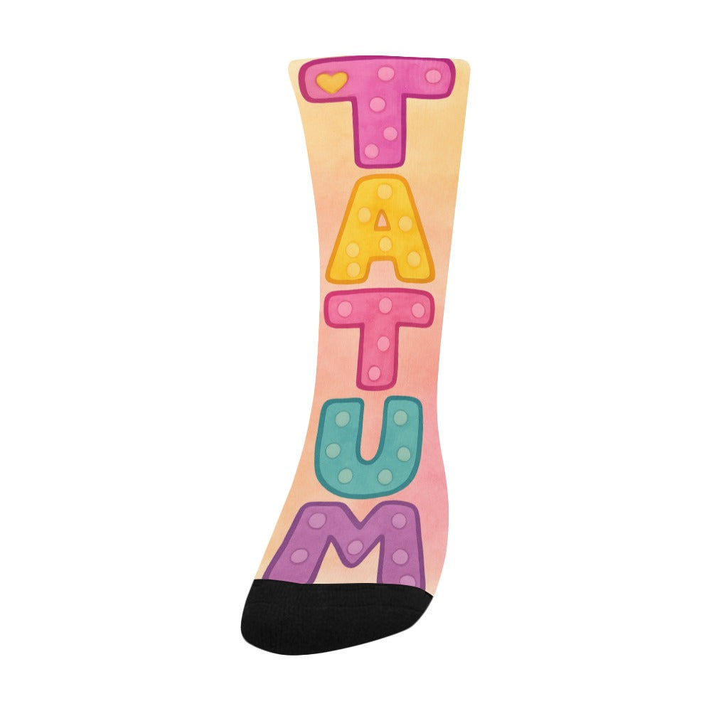 Colorful kids socks with the name Tatum in large pastel watercolor letters, inspired by the children’s book My Mommy Lives in Heaven.