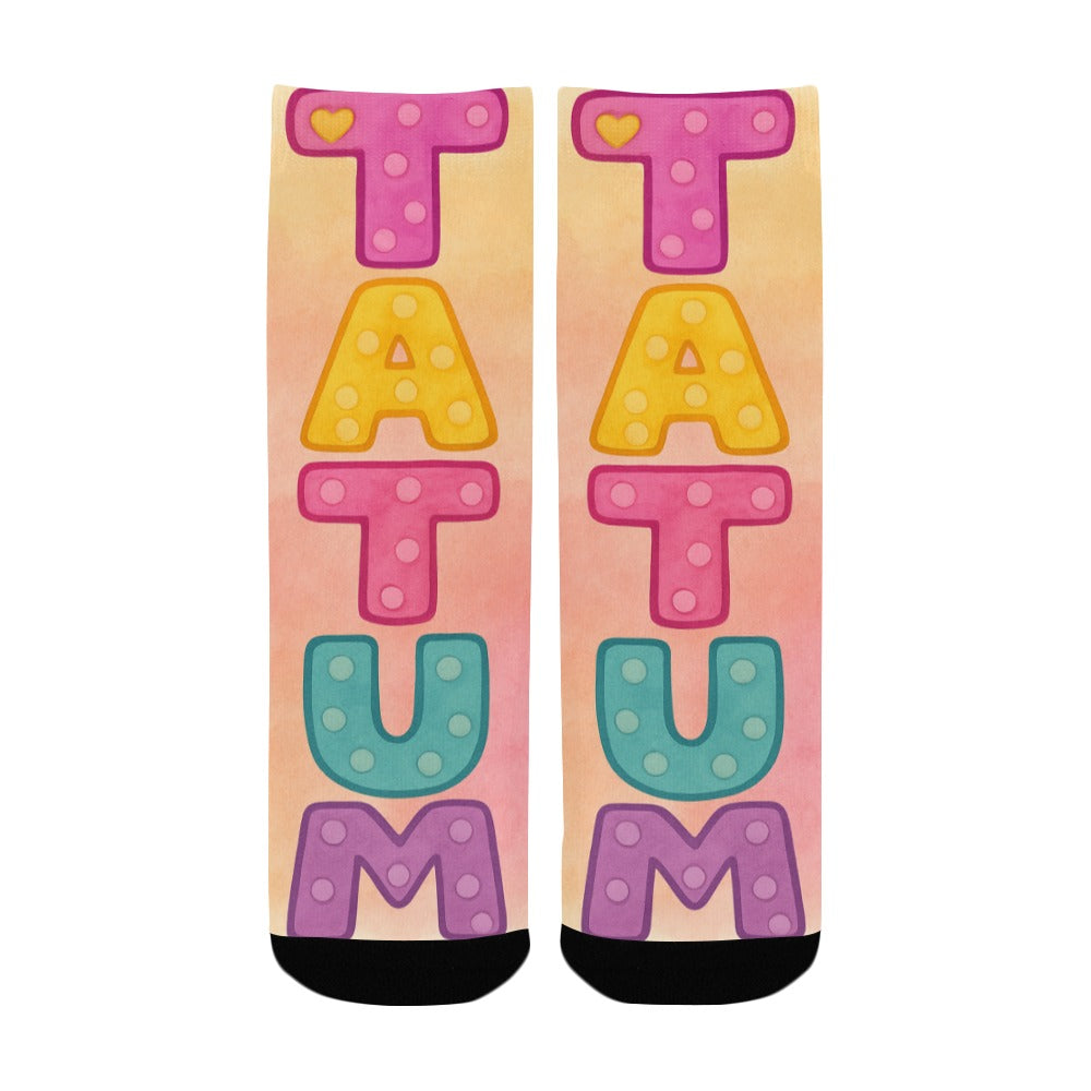 Colorful kids socks with the name Tatum in large pastel watercolor letters, inspired by the children’s book My Mommy Lives in Heaven.