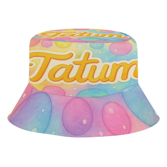 Pastel kids bucket hat with Tatum’s name in yellow script on a watercolor bubble background, featuring chin strap and foldable design.