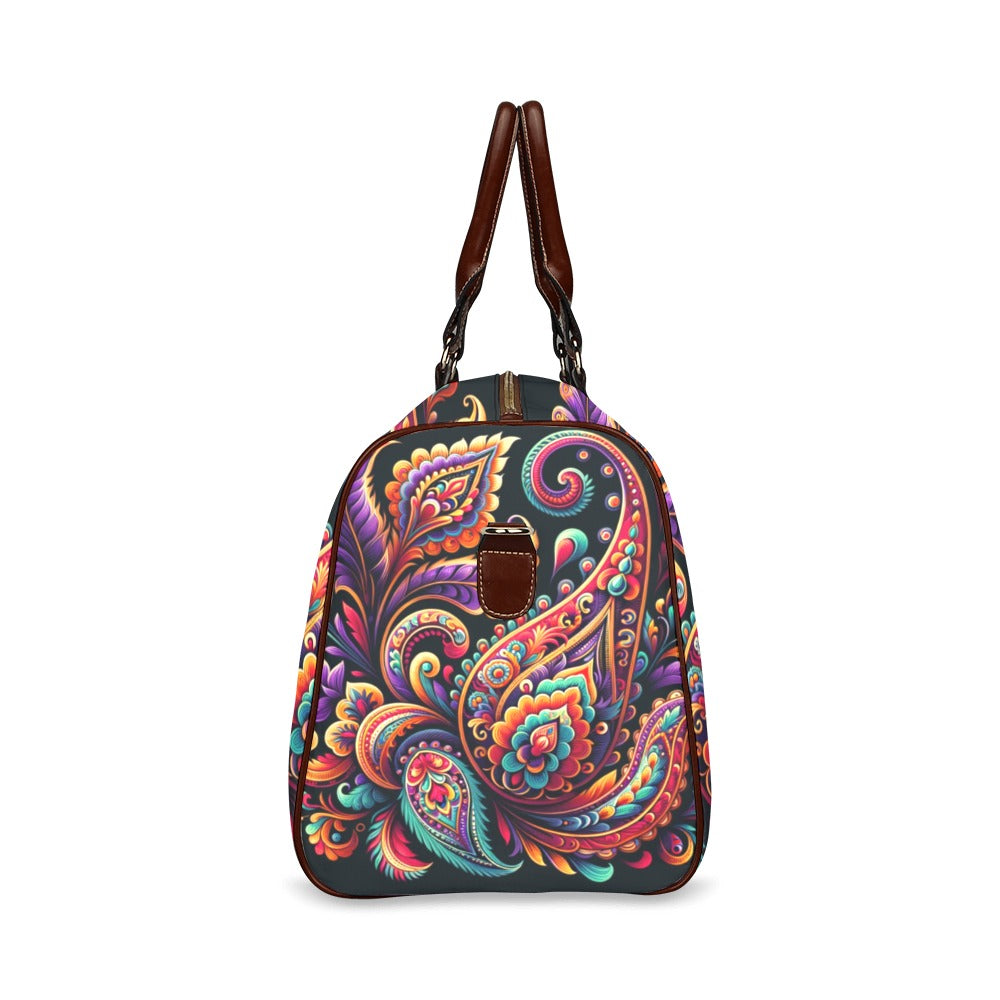 Vivid Luxe Paisley Duffel Bag with a bold colorful paisley print, waterproof fabric, and brown leather straps for stylish travel.