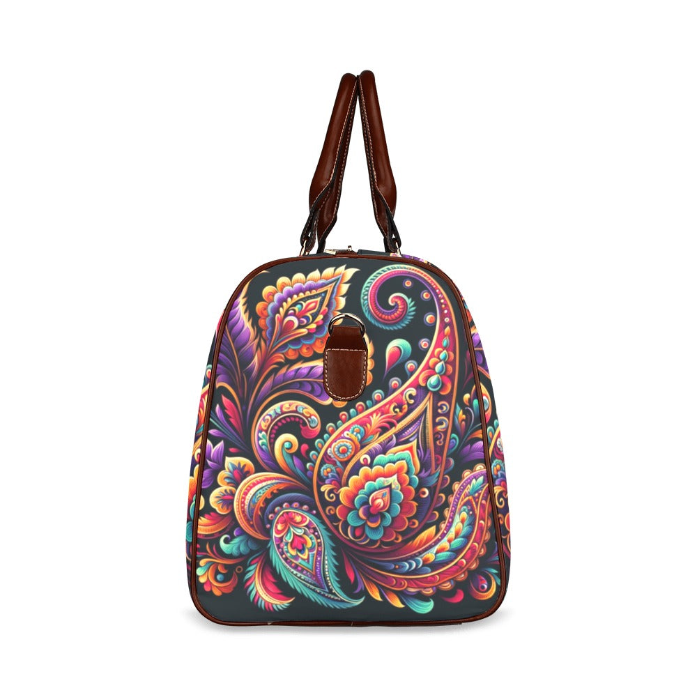 Vivid Luxe Paisley Duffel Bag with a bold colorful paisley print, waterproof fabric, and brown leather straps for stylish travel.